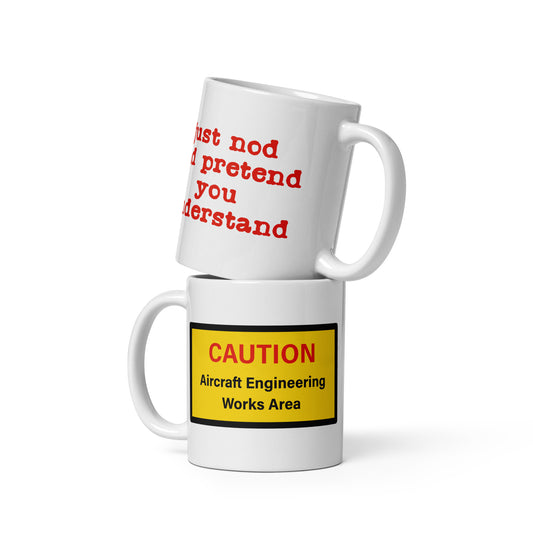 White ceramic glossy mug with "CAUTION Aircraft Engineering Works Area" on the front and the message "just nod and pretend you understand" on the back.