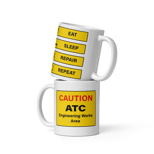 This ATC, air traffic engineer's "Eat, Sleep, Repair, Repeat" mug takes an ironic view of the average day. The design utilises the familliar black on yellow airport passenger signage found at  all airports on the back and has 'Caution" in red and "ATC engineering works area" on the front.